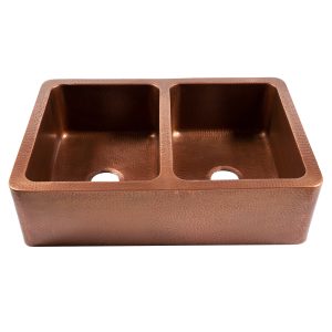 A copper rectangular undermount double basin farmhouse sink