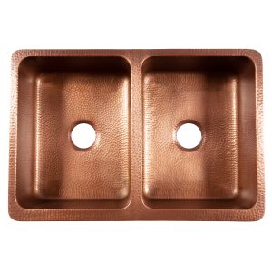A copper rectangular undermount double basin farmhouse sink.