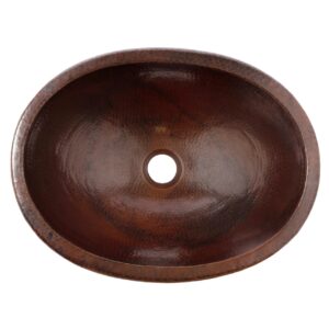 A hand hammered dual mount copper bathroom sink.