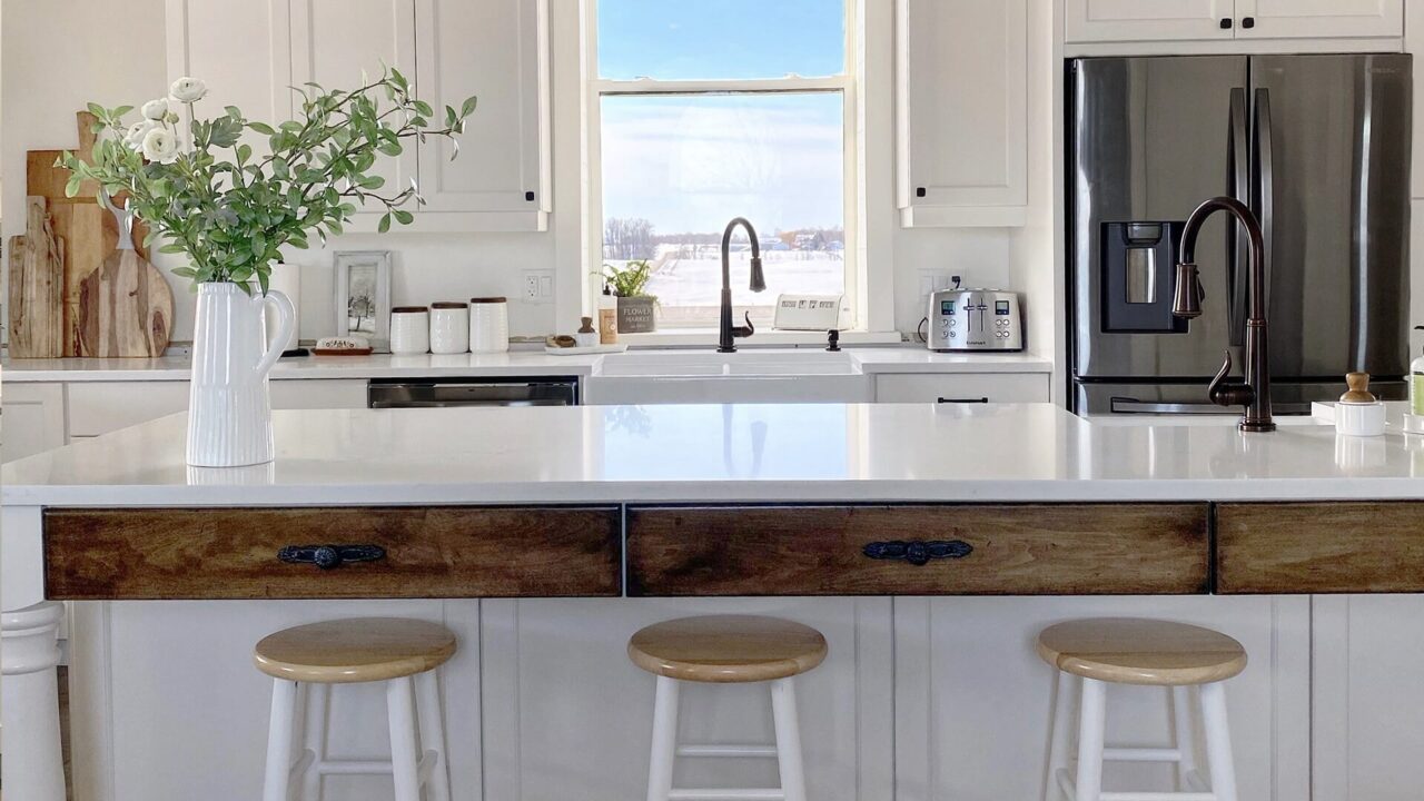A modern kitchen with blue cabinets, centered around a beautiful sink that enhances the room's appeal and usability.